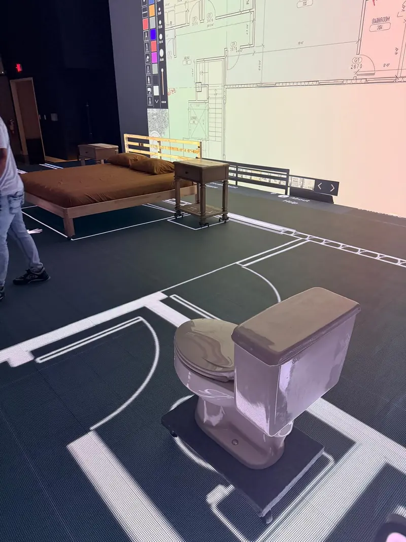 Full-scale floor plans projected on the floor for a client walkthrough